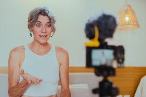 an older woman speaking live into the camera