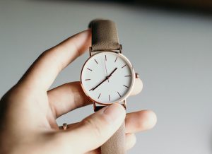 A hand holding a watch